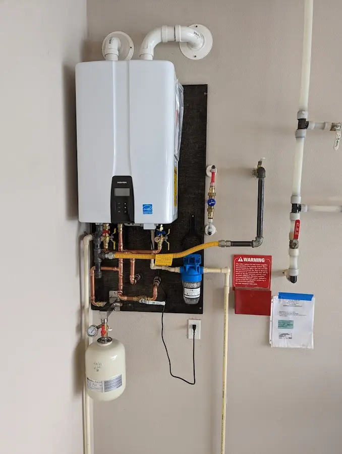 Professional plumber installing copper piping in a Owosso home